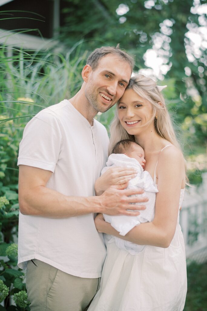 Mom and dad holding baby during newborn lifestyle photography in Indianapolis