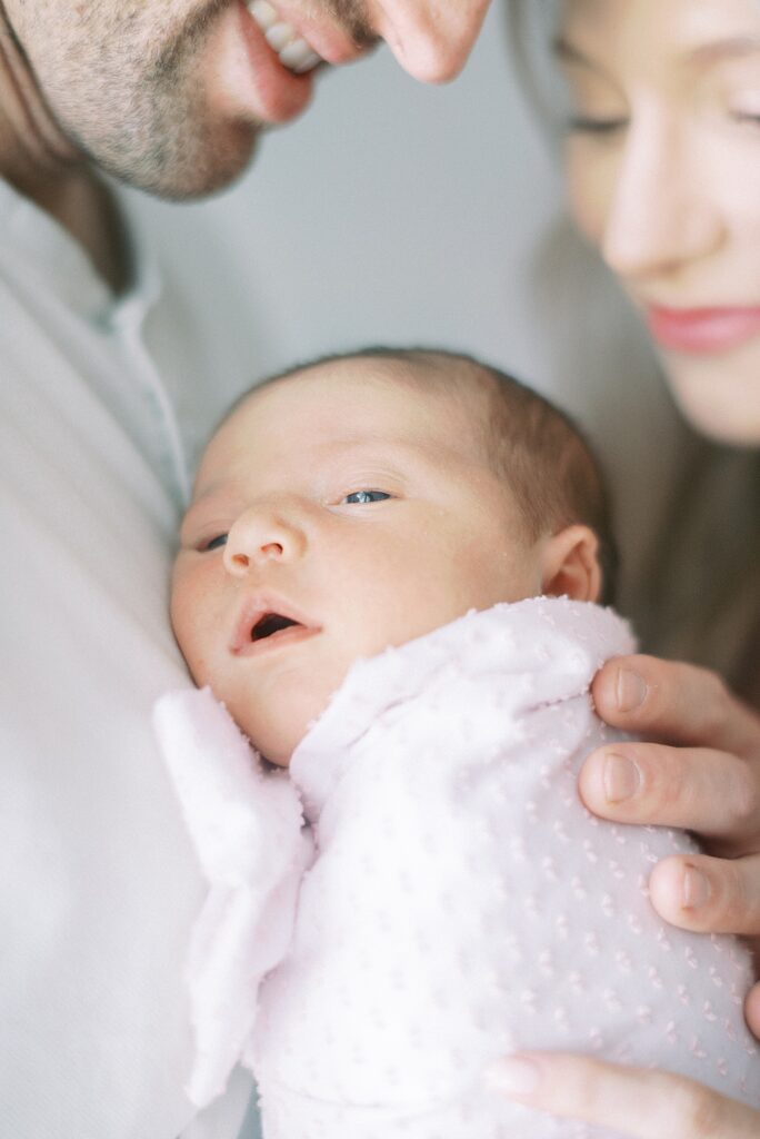 Mom and daddy holding newborn baby during newborn lifestyle photography in Indianapolis