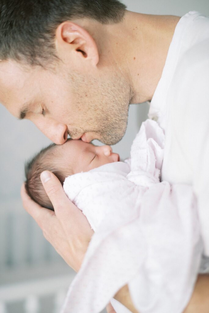 Mom and daddy holding newborn baby during newborn lifestyle photography in Indianapolis