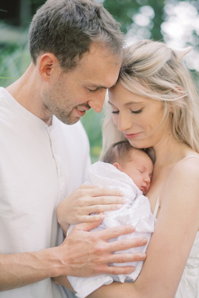 Mom and daddy holding newborn baby during newborn lifestyle photography in Indianapolis