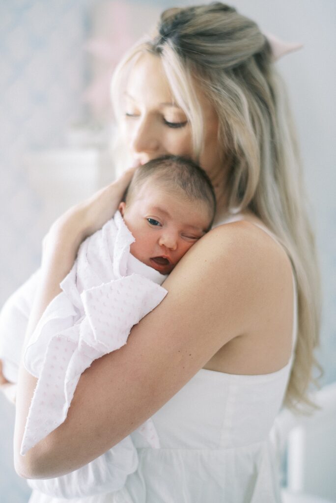 Mom and daddy holding newborn baby during newborn lifestyle photography in Indianapolis