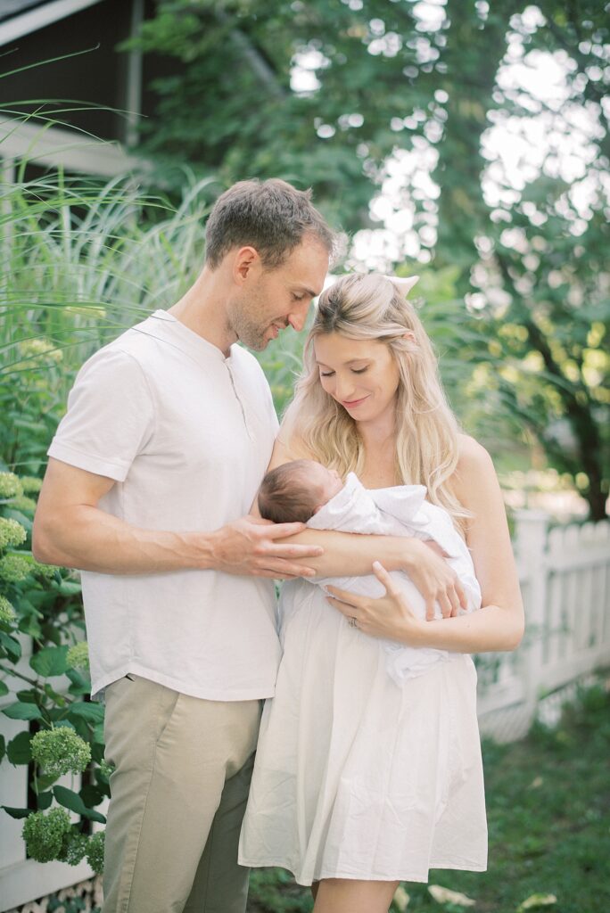 Mom and daddy holding newborn baby during newborn lifestyle photography in Indianapolis